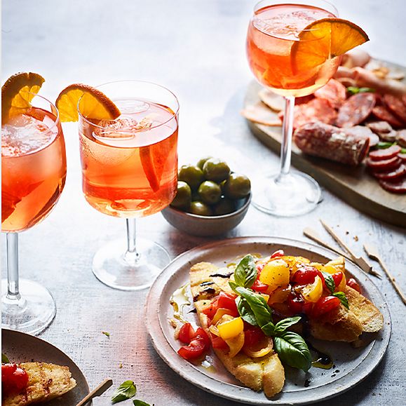 Isle of Wight tomato bruschetta, a charcuterie board, olives and glasses of aperitivo spritz