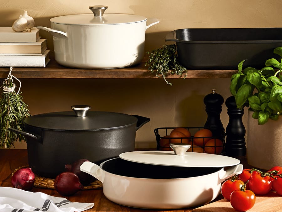 Black and white cookware on a kitchen shelf. Shop cookware