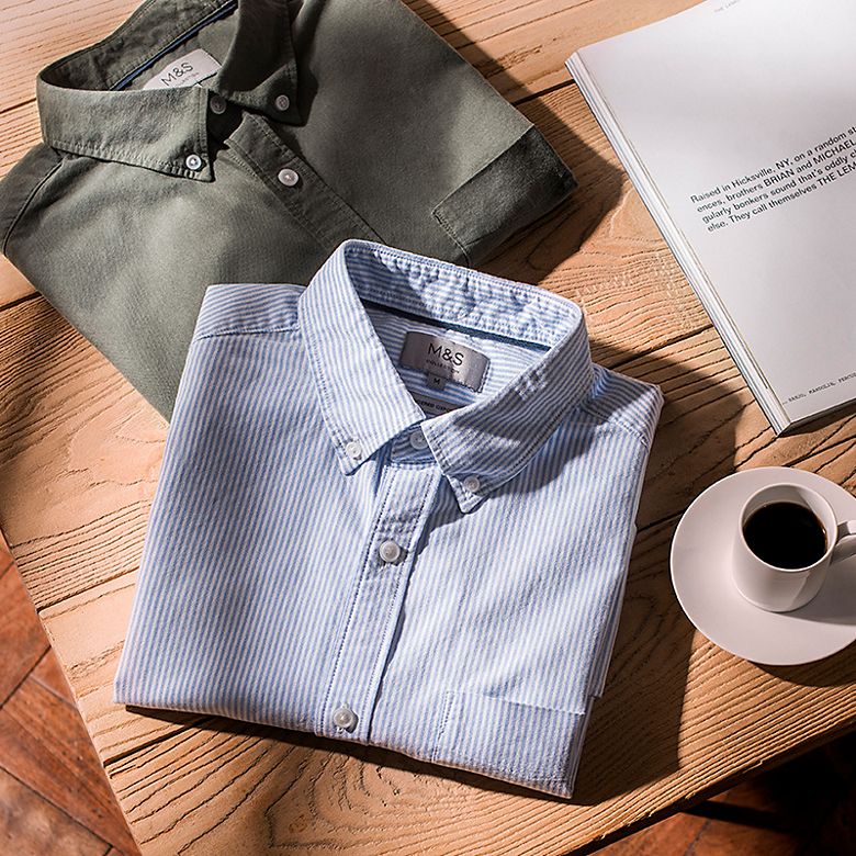 Men’s Oxford-collar shirts folded on a table