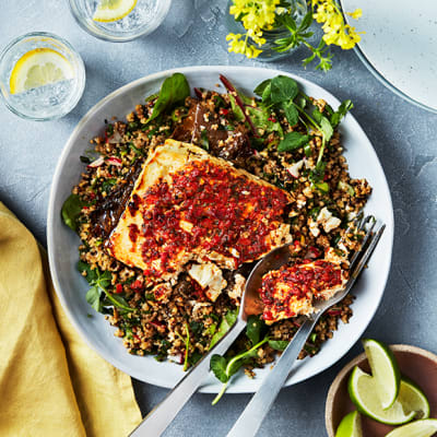 Whole feta bake with harissa and a grain and leaves salad