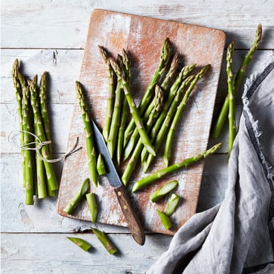 Green asparagus on a wooden chopping board