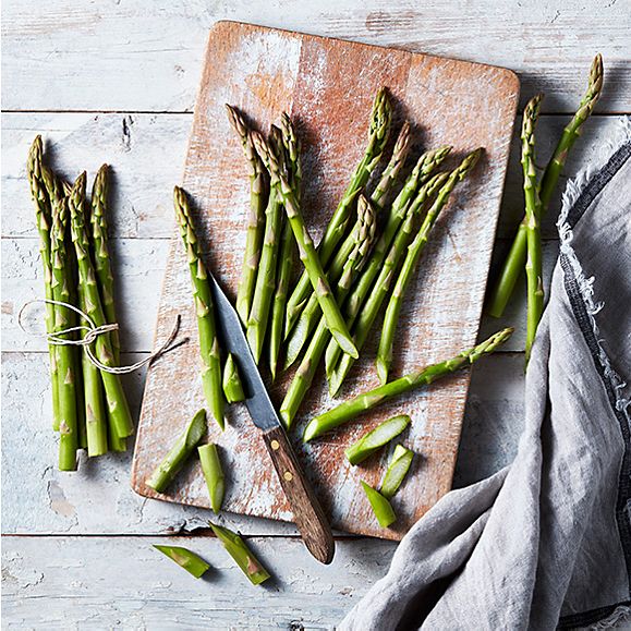 Green asparagus on a wooden chopping board