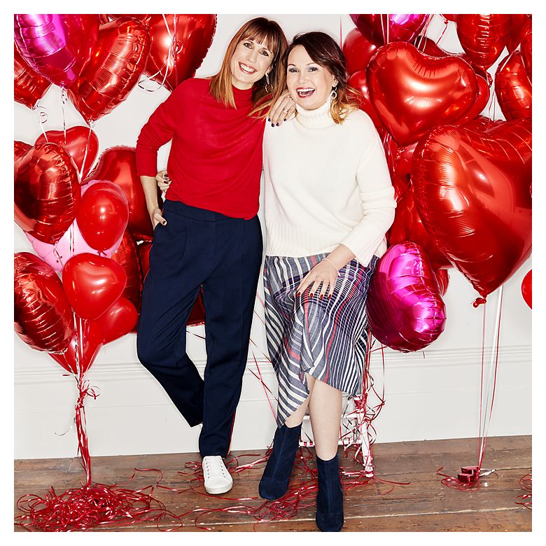 Nathalie Bailey-Flitter and sister Tanya Walker smiling in front of red love heart balloons