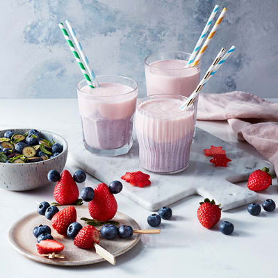 Mixed berry smoothies with blueberry salad and fresh fruit skewers