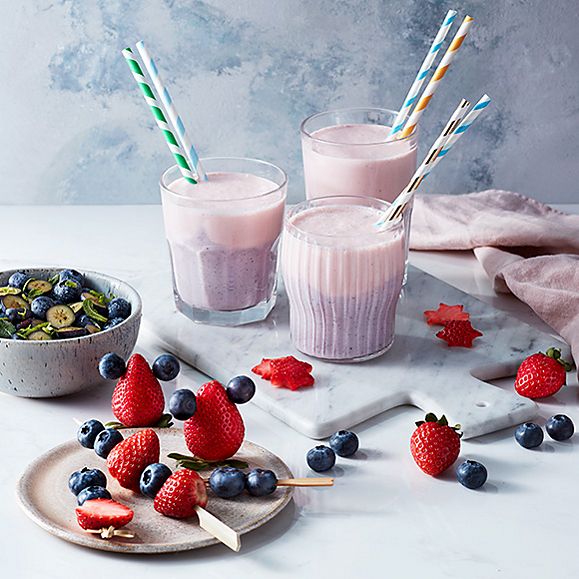 Mixed berry smoothies with blueberry salad and fresh fruit skewers
