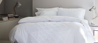 White bedding on double bed