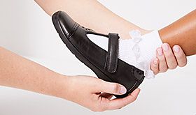 Adult holding child's foot while gripping the heel