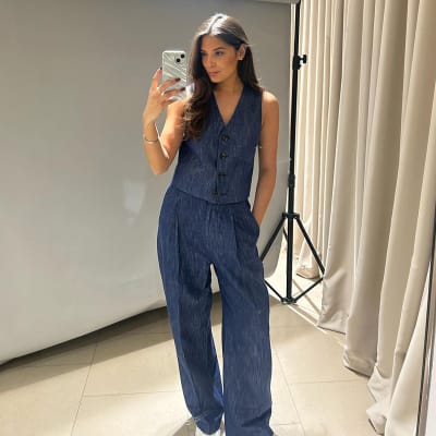 Instagram star @carolinesstylehacks wears blue denim blazer, blue denim waistcoat and blue denim pleated high-waisted trousers. Shop women’s waistcoats 