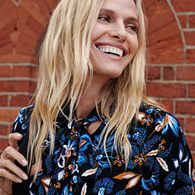 Woman wearing a blue floral pussy-bow blouse