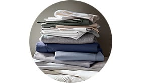A pile of folded plain bed linen