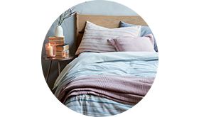 Striped bed linen on a wooden bed