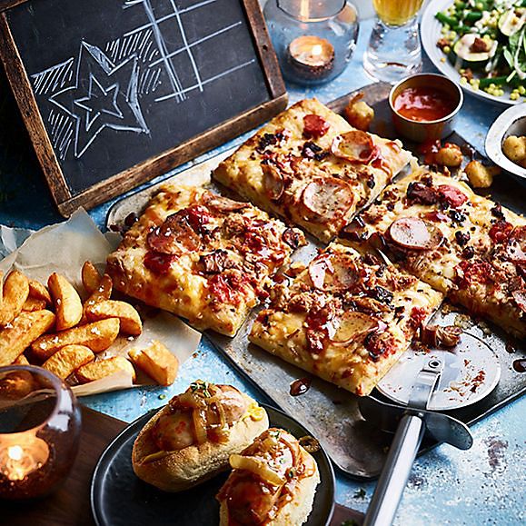 A selection of Big Night In treats including Detroit-style Whole Hog Pizza, Triple-Cooked Chips and Mini Posh Dogs 