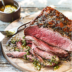English oak-smoked beef rump on a wooden board