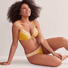 Woman wearing ochre bra and knickers set