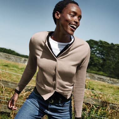 Natasha Luwedde wearing a beige crew-neck cardigan