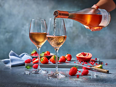 A bottle of rosé wine and two glasses