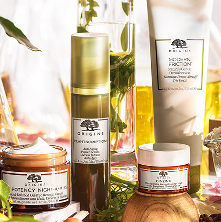 Origins skin care products surrounded by botanicals