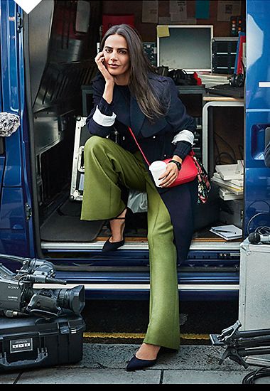 Woman wearing navy mac, green trousers and red bag, 2017