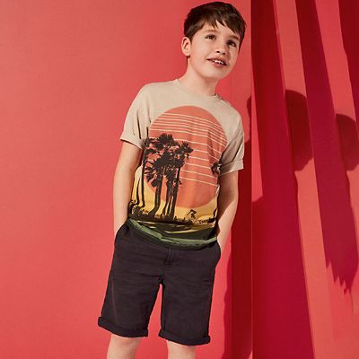 Boy wearing T-shirt and shorts
