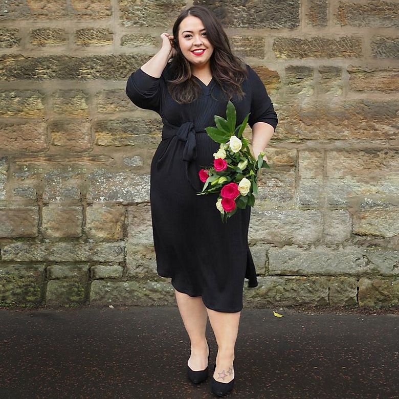 M&S Insider Nicola holding roses, wearing black column dress for Valentine’s Day