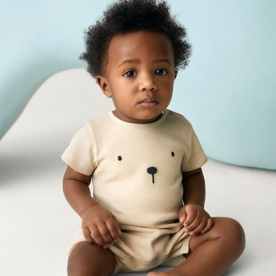 Baby wearing bear romper. Shop new-in baby clothing