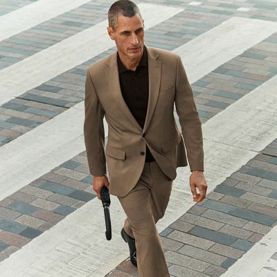 Man wearing brown suit. Shop all suits
