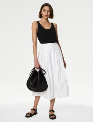 M&S white cotton box pleat midi skirt. With its breathable pure cotton fabric, this skirt is an ideal choice for warmer days. It's cut in a flowing A-line silhouette, with a box pleat that creates extra volume. The hemline sits at an on-trend midaxi length. This piece is lined for comfort, and fastens with a neat zipper. M&S Collection: easy-to-wear wardrobe staples that combine classic and contemporary styles.