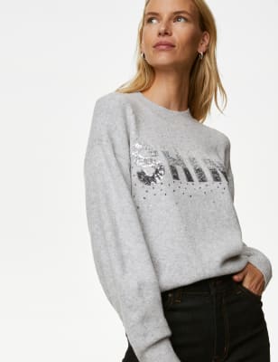 Pull à col rond avec texte orné de sequins