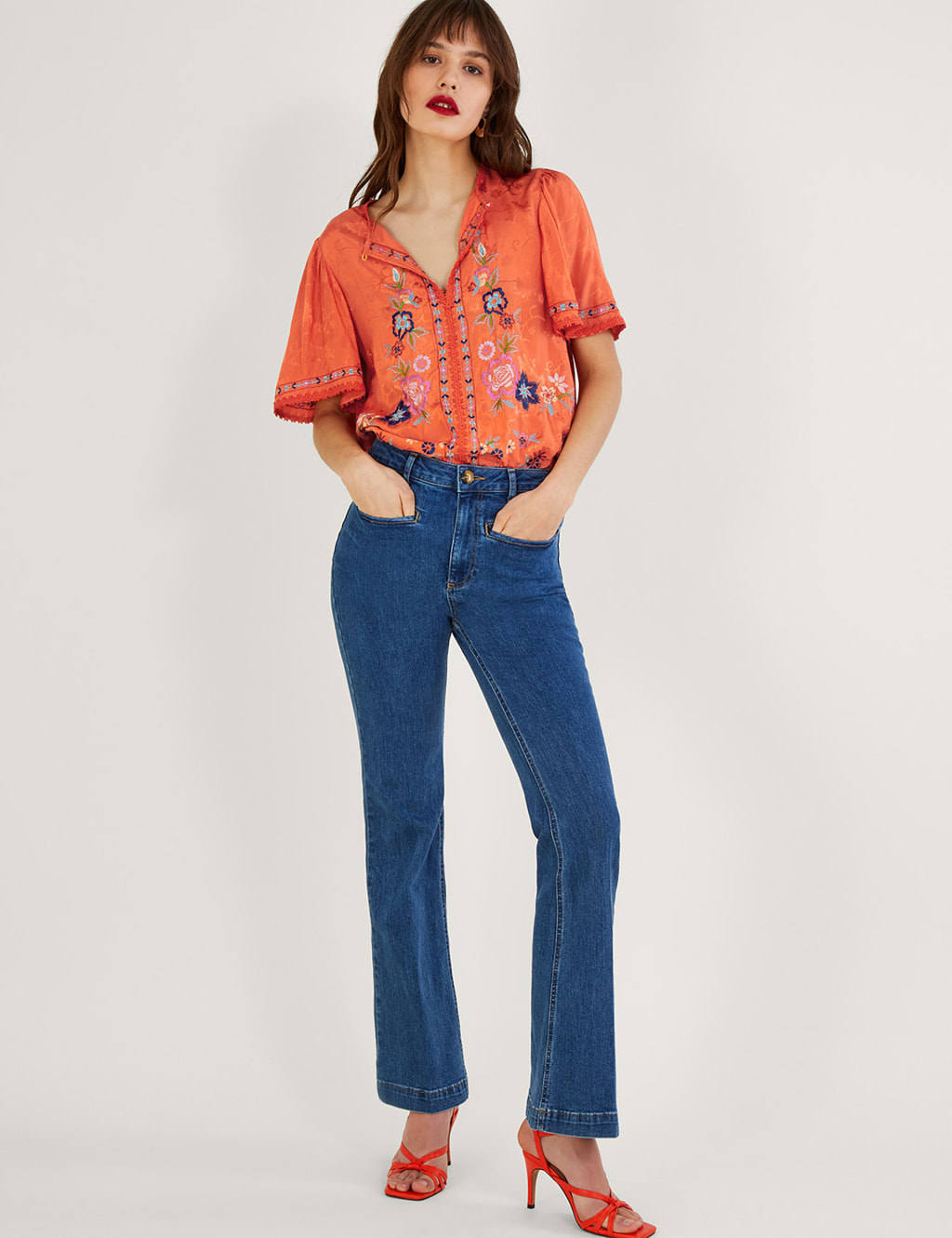 Orange half sleeve women’s blouse.
