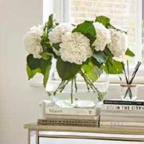 Artificial hygrangea in glass vase