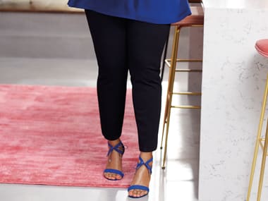 Model wearing a black trouser and blue top from the Curve collection