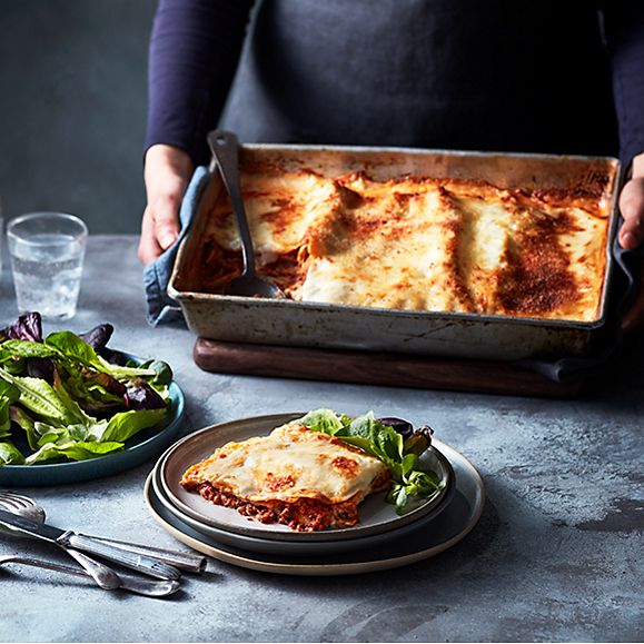 A large, family-sized lasagne and green salad