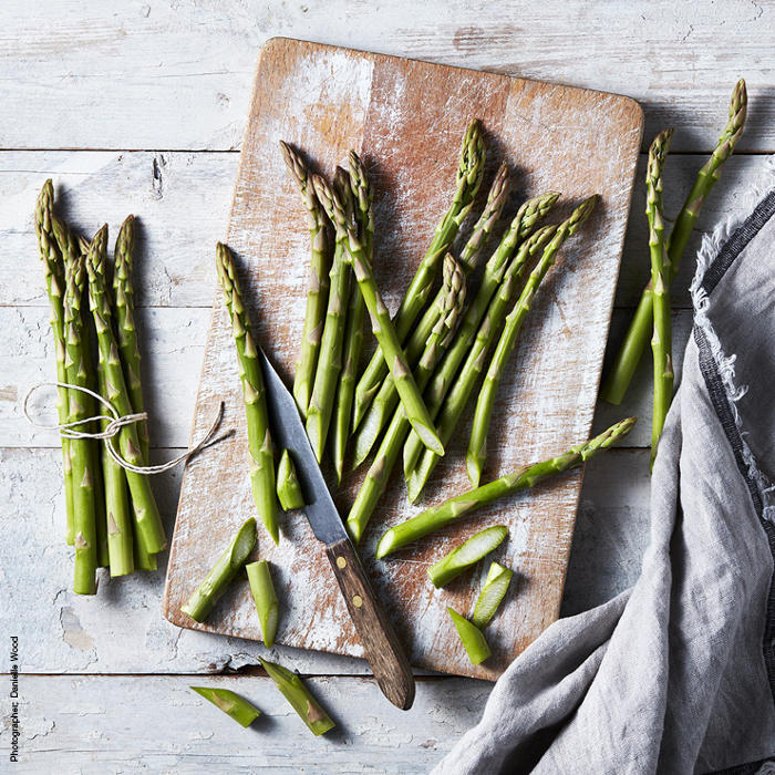 Fresh raw asparagus on a chopping board