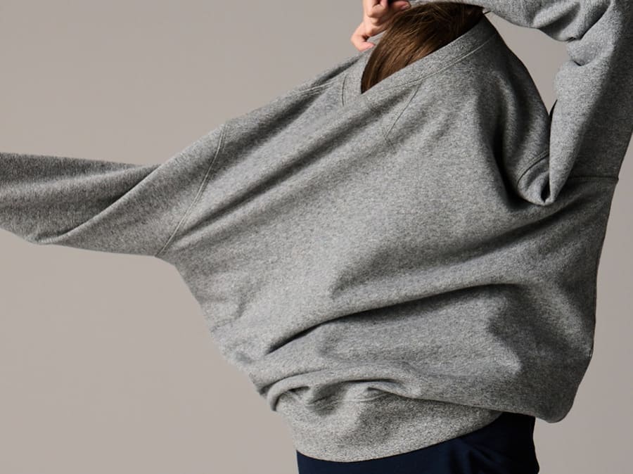 Woman wearing a sweatshirt. Read more about our cotton